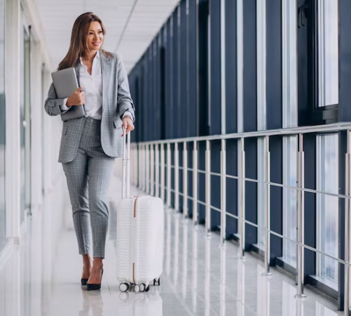 business-woman-with-travel-luggage-airport-holding-laptop_1303-20377